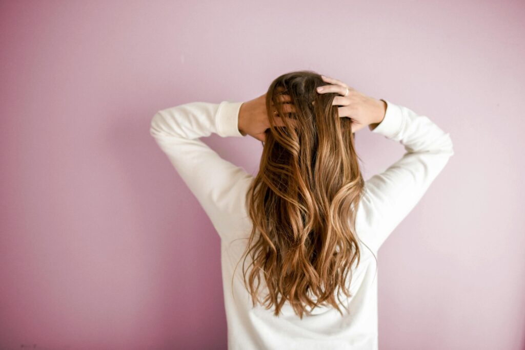 Women holding her brown hair | JLO Beauty Supply in Sarasota, FL